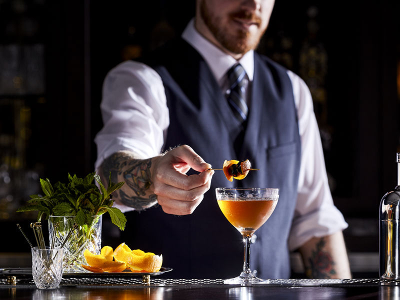 Bartender Garnishing A Cocktail